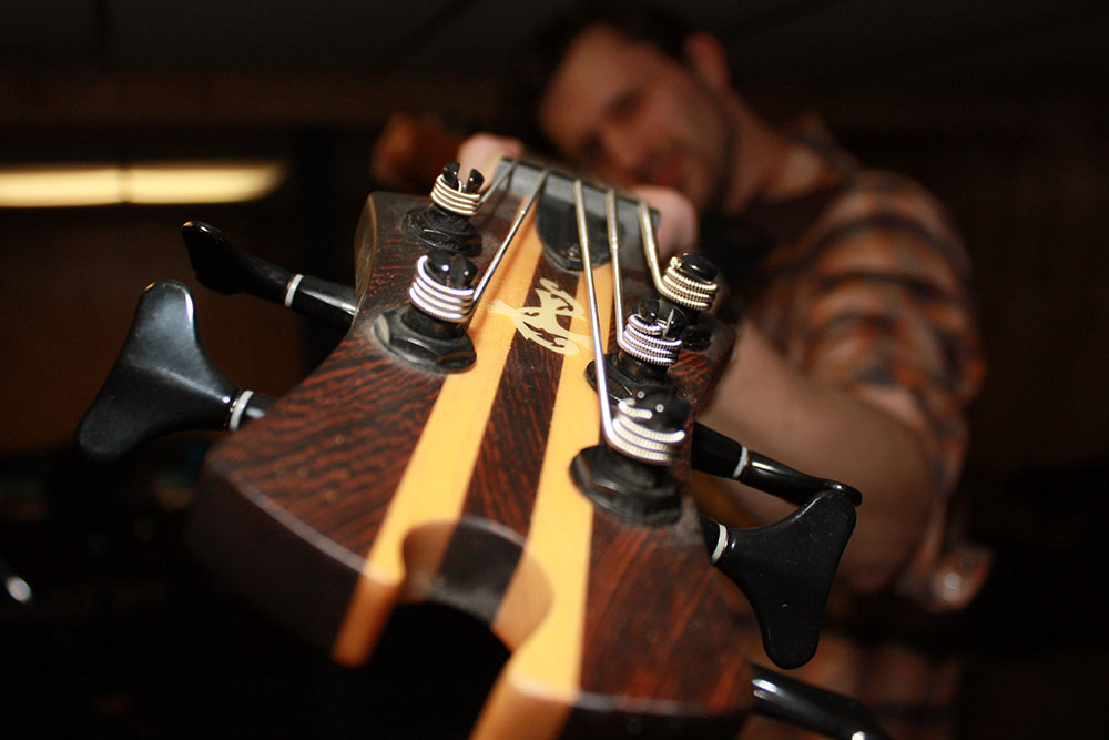 anthony carrozzo holding bass close up to camera